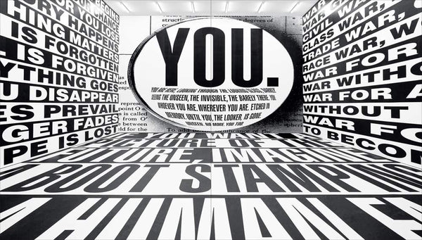 A room with black and white writing all over the walls, including the word "You" in capital letters in the middle of the room.