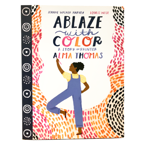 A colorful book cover depicting a woman with a dark skin tone painting the name "Alma Thomas." The title reads: "Ablaze with Color: A Story of Painter Alma Thomas." 