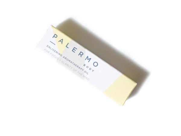 Yellow and beige packaging with the text: "Palermo Body. Enlivening Aromatherapy Oil."