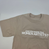 Close up of a beige t-shirt in front of a white background. On the t-shirt, text in white capital letters reads: "Can you name five women artists?"