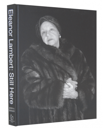 Book cover in black with a photograph of a woman wearing a fur. The title reads "Eleanor Lambert: Still Here."