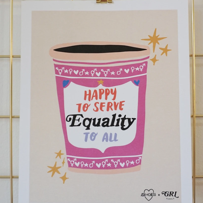 Print with a pink and white to go cup and text in red and black printed onto it. The text reads "Happy to serve equality to all."