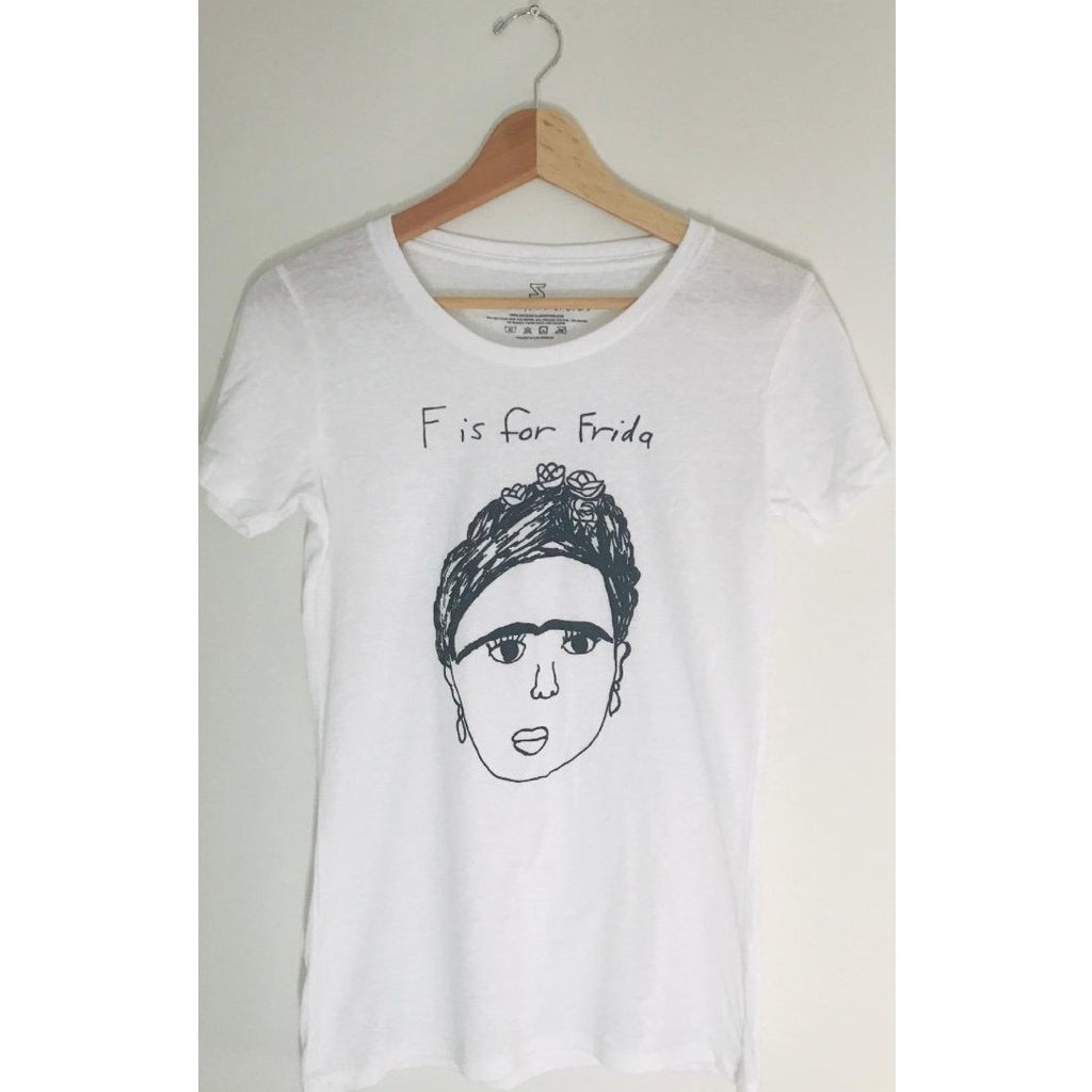 White t-shirt with an illustration of a woman and the text "F is for Frida."