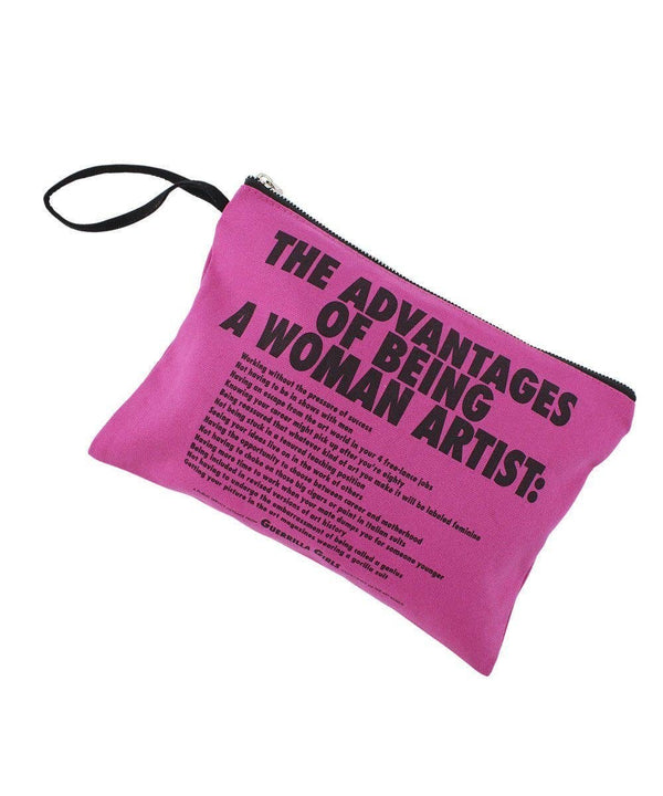 Pink clutch with a black zipper and text that reads: "The Advantages of Being a Woman Artist."
