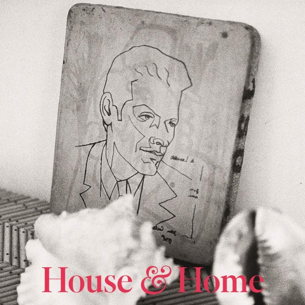 A black and white magazine featuring a portrait drawn on a slab of concrete. the words "House & Home" are written in red lettering on the bottom. 